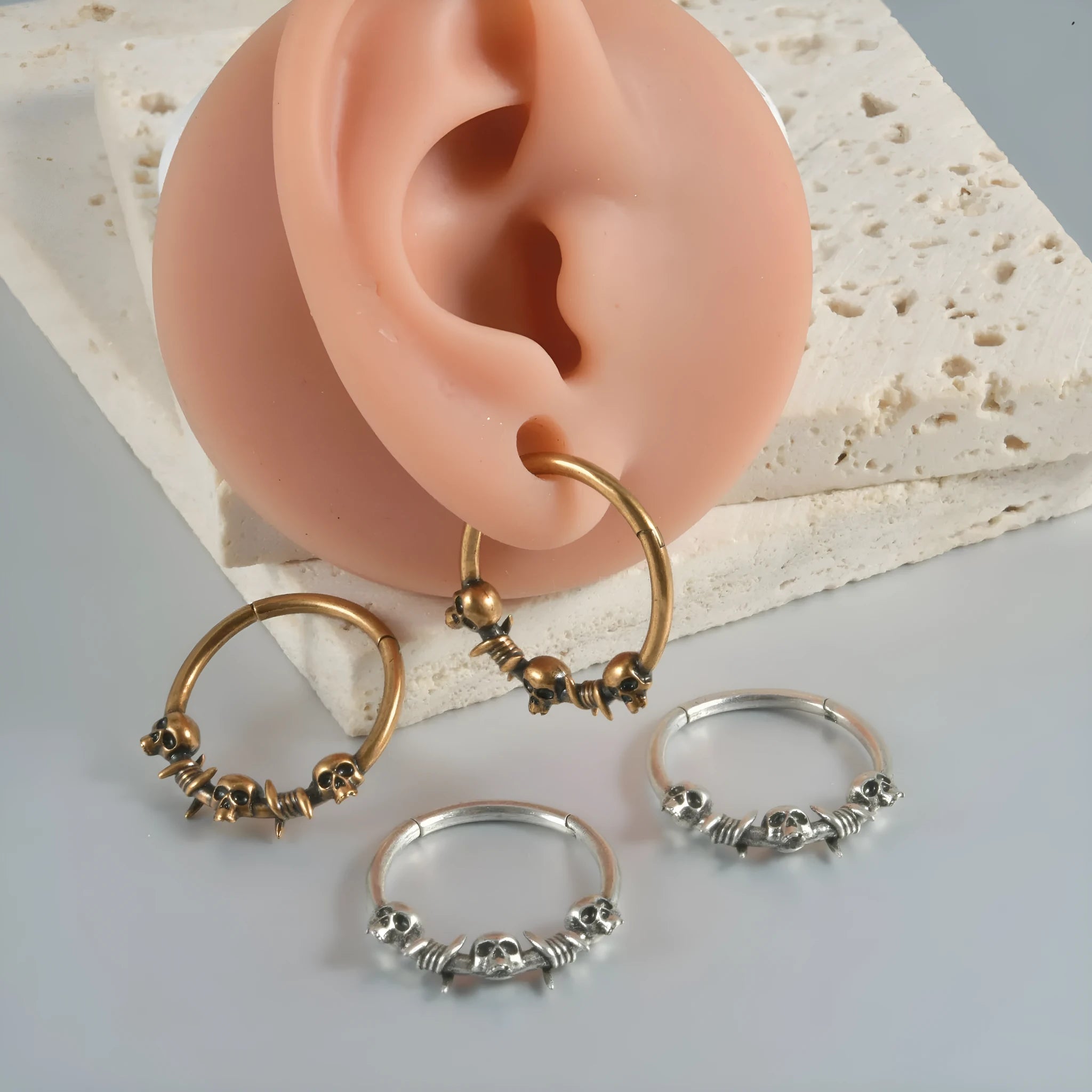 Close-up of copper punk earrings with a detailed ghost head design in antique silver finish.