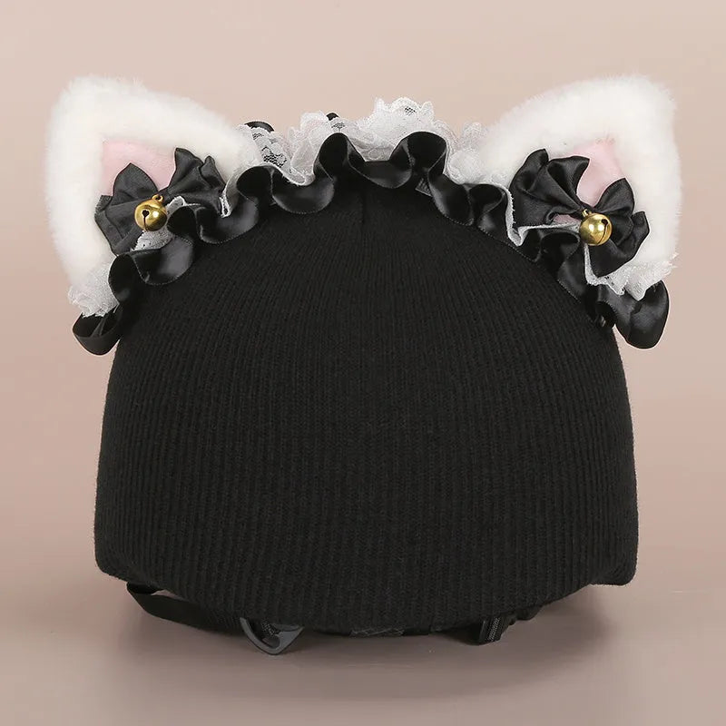 Soft plush cartoon character cover on a motorcycle helmet, showing size M and decorative ear sections.