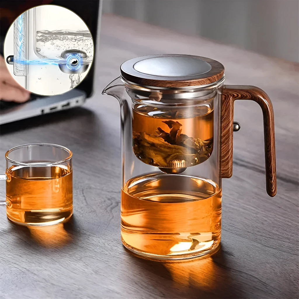 Glass teapot with wooden handle showing magnetic tea separation button and detachable inner infuser.