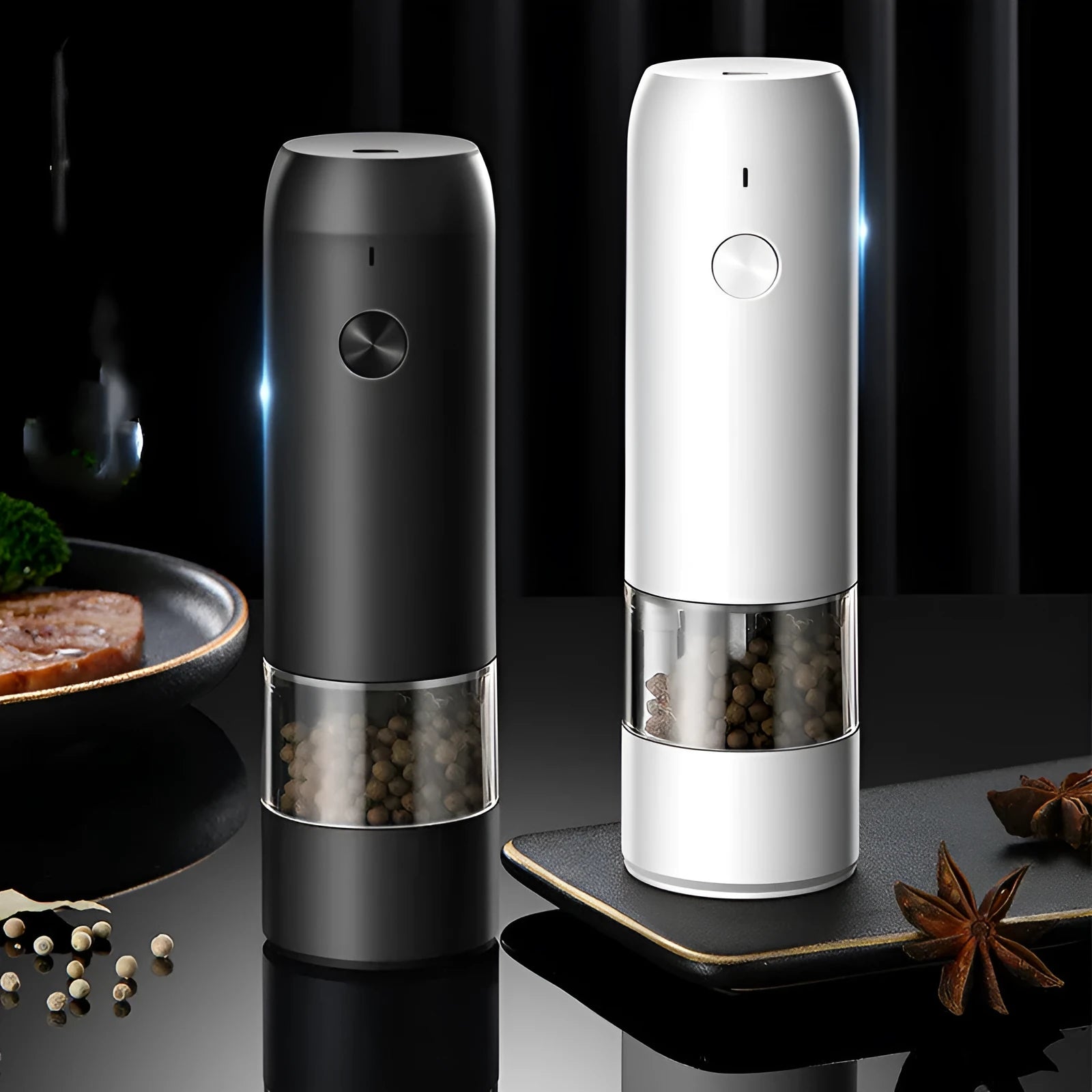 Black and white electric salt and pepper grinder set with USB charging cable on a kitchen worktop.