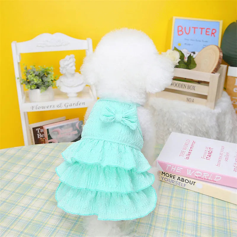 Small dog wearing polyester princess dress with layered skirt in candy colours