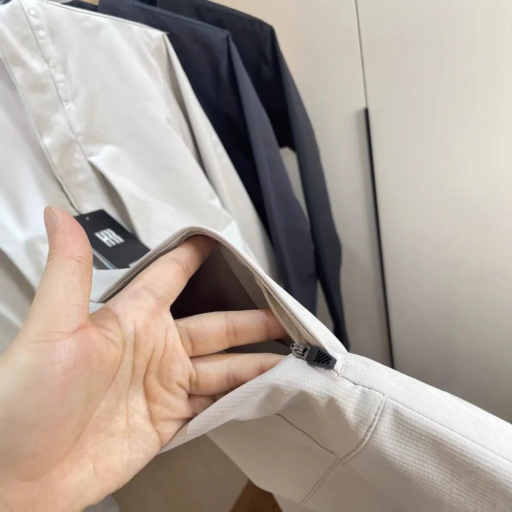 Men's beige stand collar casual sports jacket with long sleeves on a hanger.