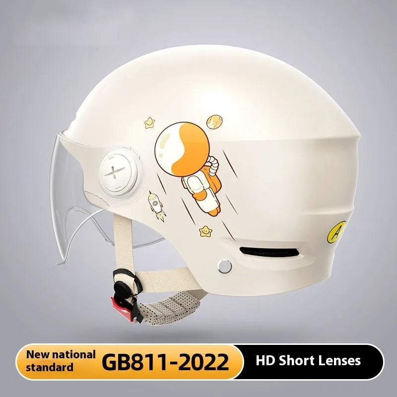 Khaki-coloured electric motorcycle half helmet with attached long glasses on a grey background.