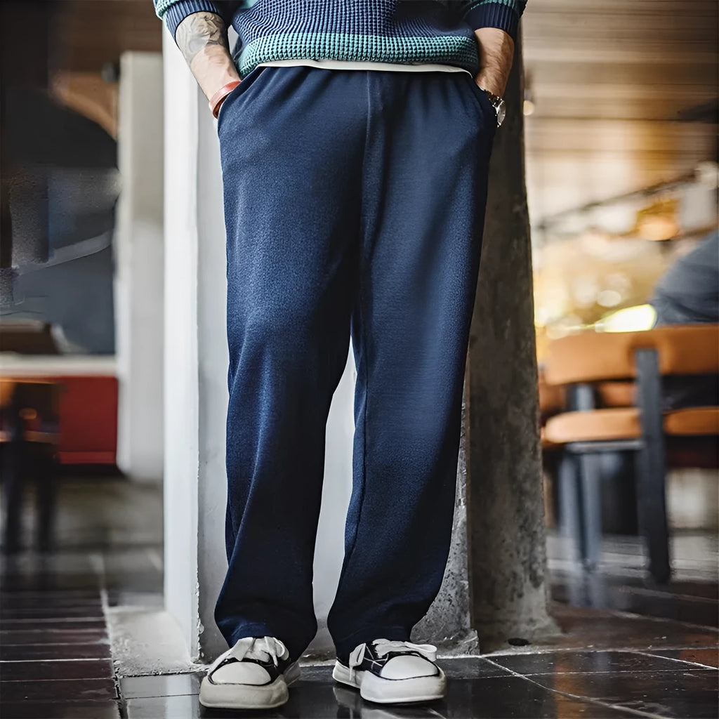 Men's indigo polyester straight fit casual trousers with micro elastic waist, front view