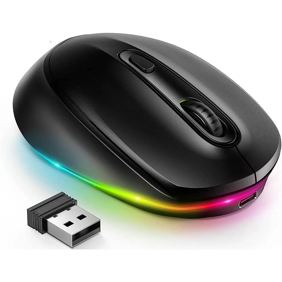Light grey wireless ergonomic mouse with USB charging cable on a wooden desk.