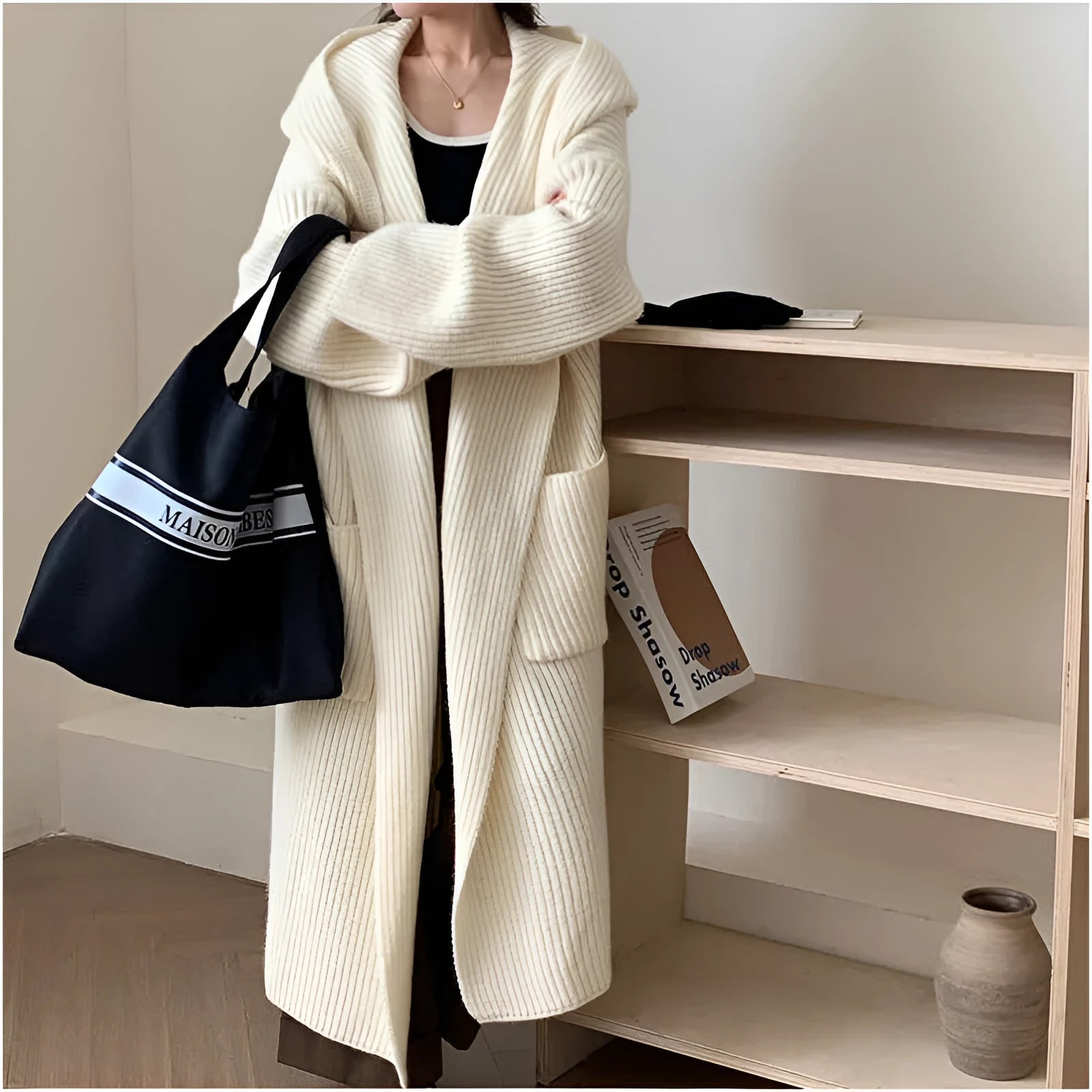 Women's loose grey hooded longline acrylic cardigan coat with raglan sleeves laid flat