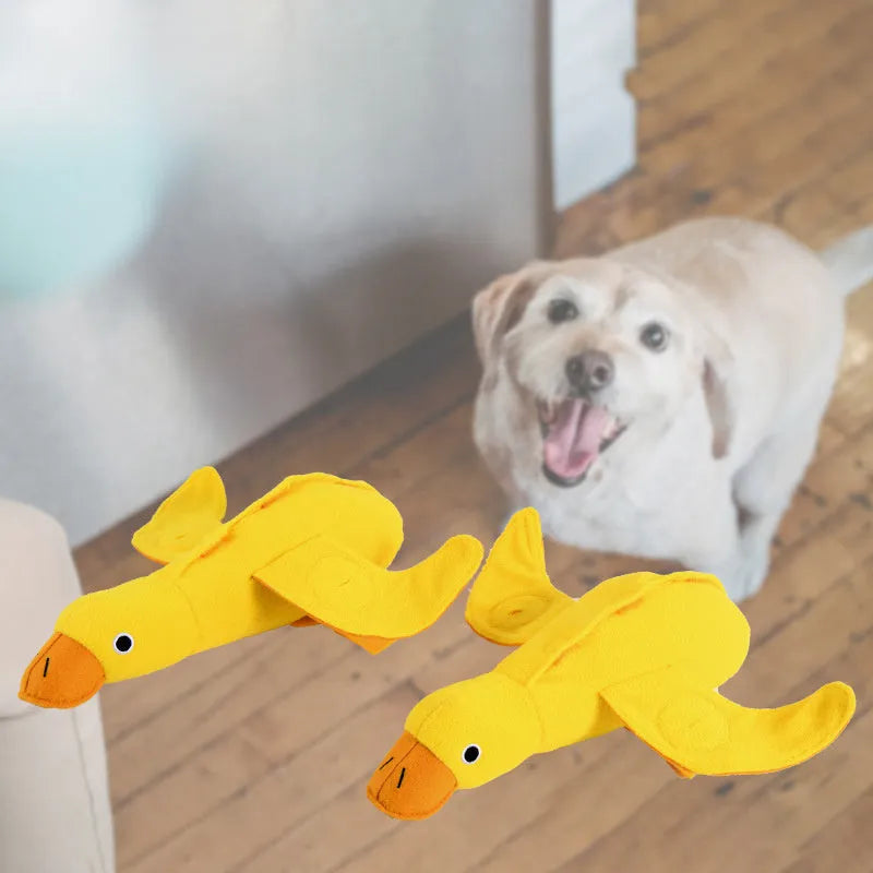 Yellow teddy duck dog toy with food leak openings for treat dispensing during training and play