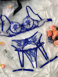 Women's embroidered underwear set with see-through mesh cutouts and matching garters in sapphire blue.