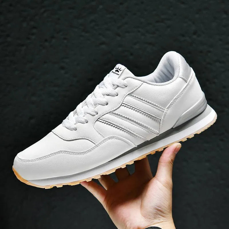 Men's black sports casual shoes with a carved wing pattern on the leather upper and a round toe.
