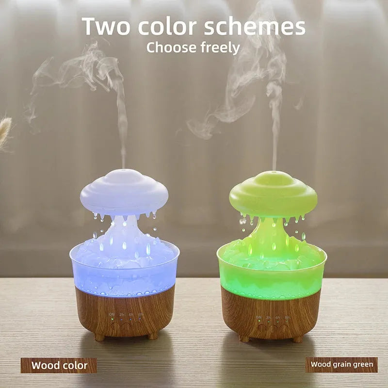 Wood grain white cloud-shaped humidifier diffuser with LED lights and water drop rain effect on a table.