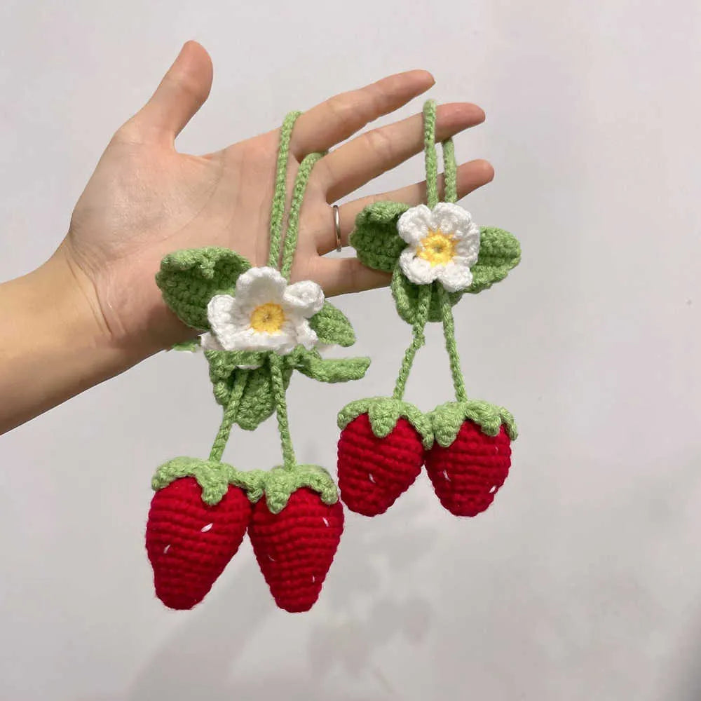 Handmade strawberry-shaped car pendant knitted from cotton and hemp wool.