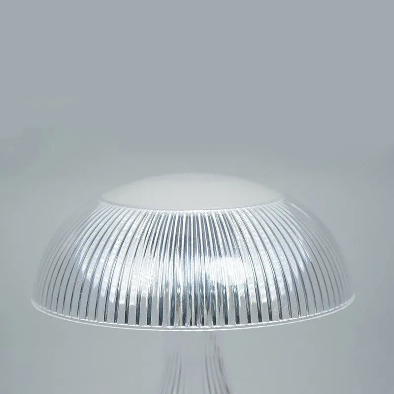White acrylic touch night lamp with USB charging port on a wooden table.
