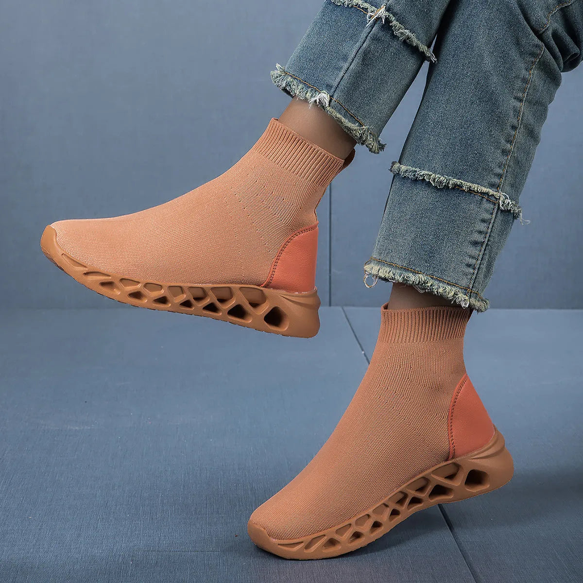Women's black mesh slip-on casual shoe with a low-top, sock-like ankle design and flat sole.