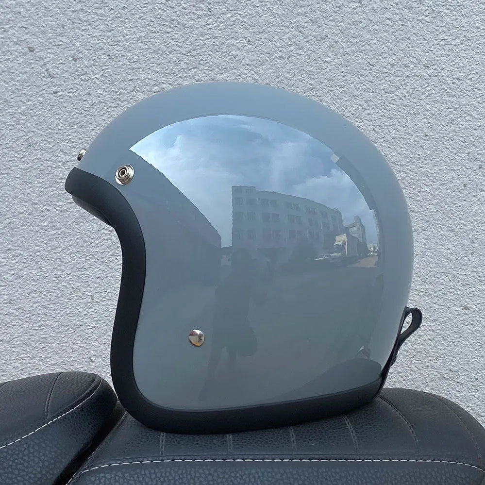 A retro-styled half motorcycle helmet made from glass fibre, shown in a matte black flower colour finish.