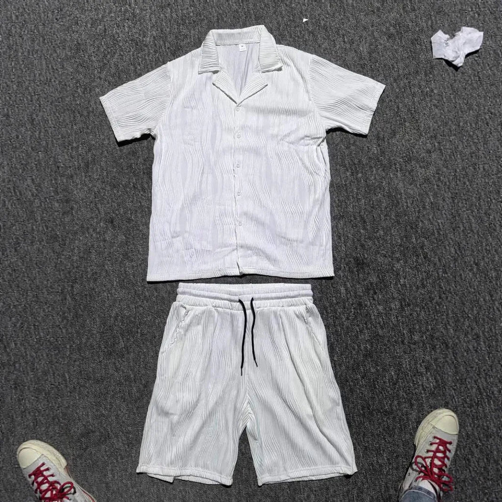 Men's black wave pattern short sleeve top and matching shorts casual set on a hanger.