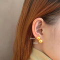 Women's geometric pearl stud earrings with silver settings and retro styling
