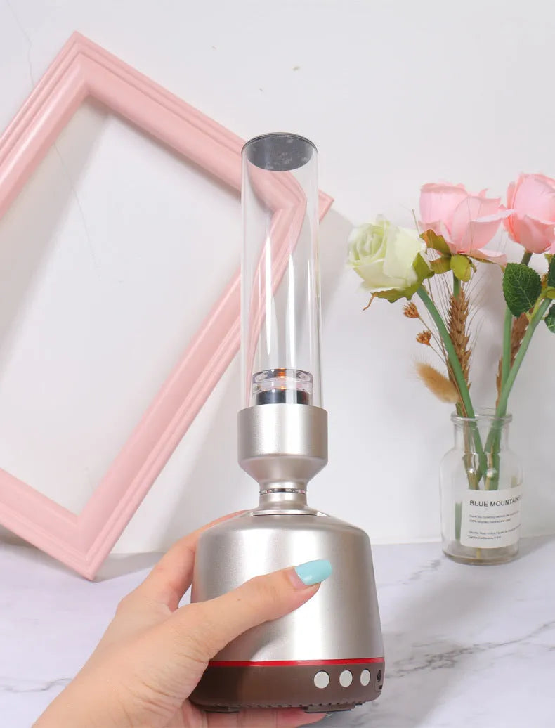 White Silver Candlelight Bluetooth speaker and night light with modern cylindrical design.