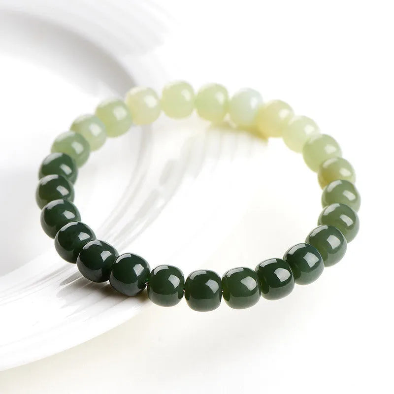 Natural Hetian jade water gradient bracelet with polished beads on a wrist.