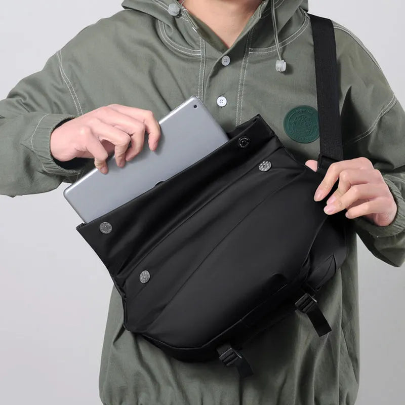 A medium-sized grey crossbody bag for men made from PU leather with a single shoulder strap.