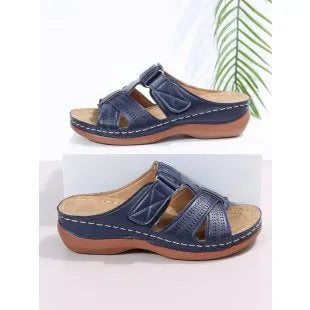 Women's black wedge sandals with a peep toe and Velcro fastening strap.