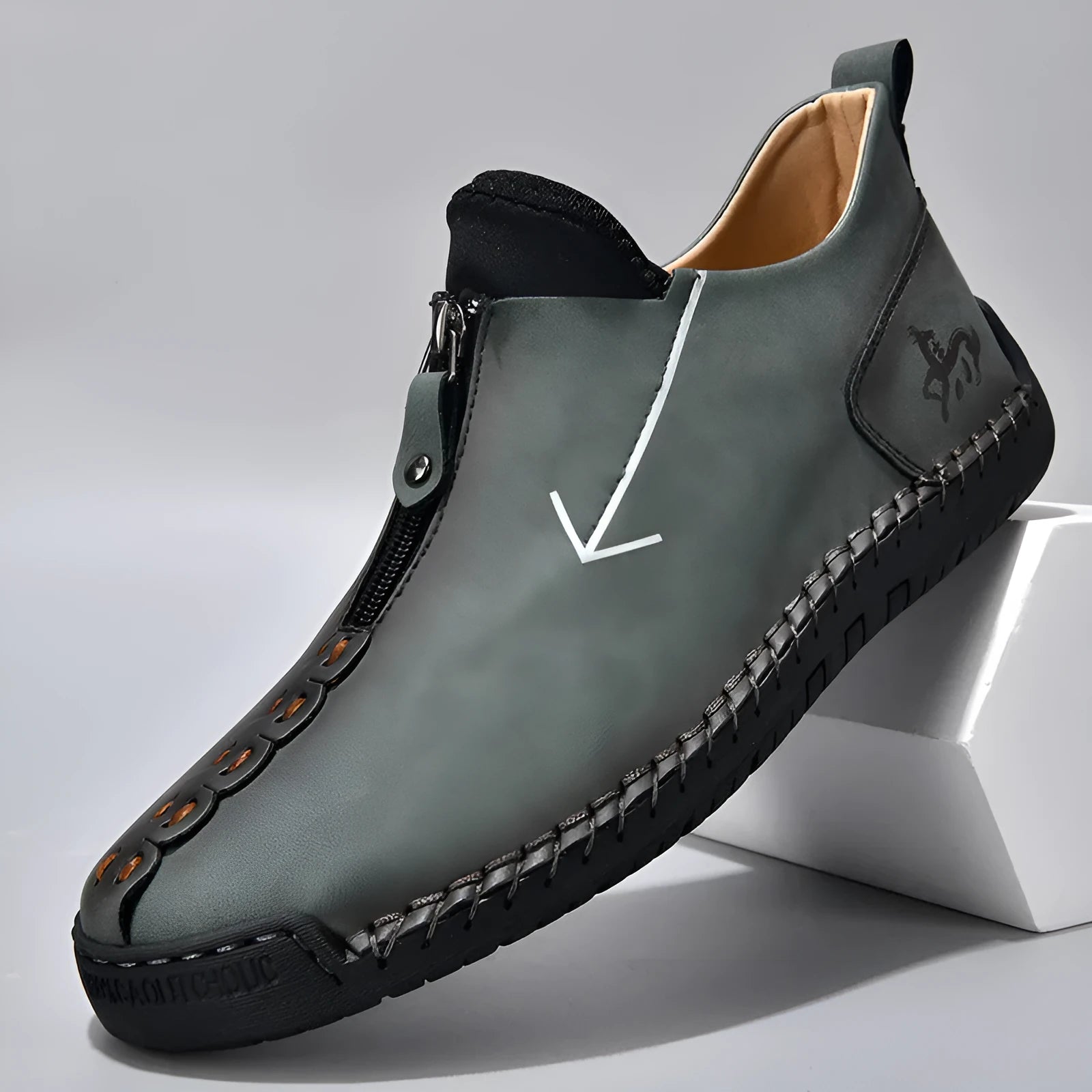 Men's black leather zip-up martin boots with round toe and low heel on a rubber sole.