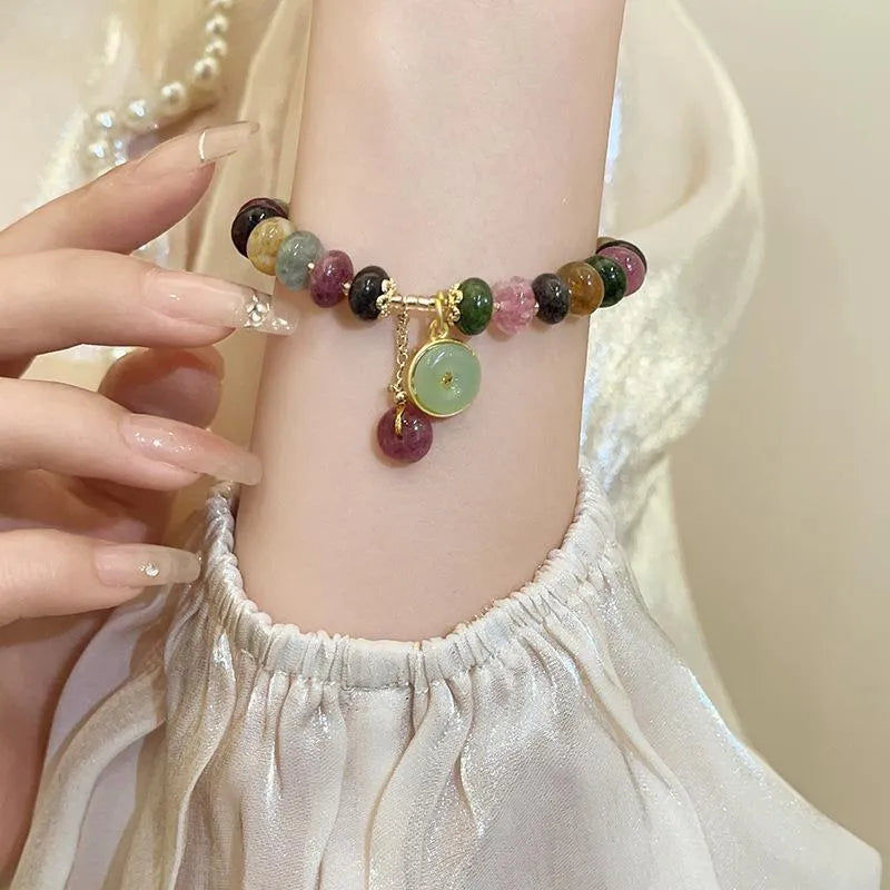 Colourful tourmaline bracelet with rabbit pendant and round abacus beads on wrist