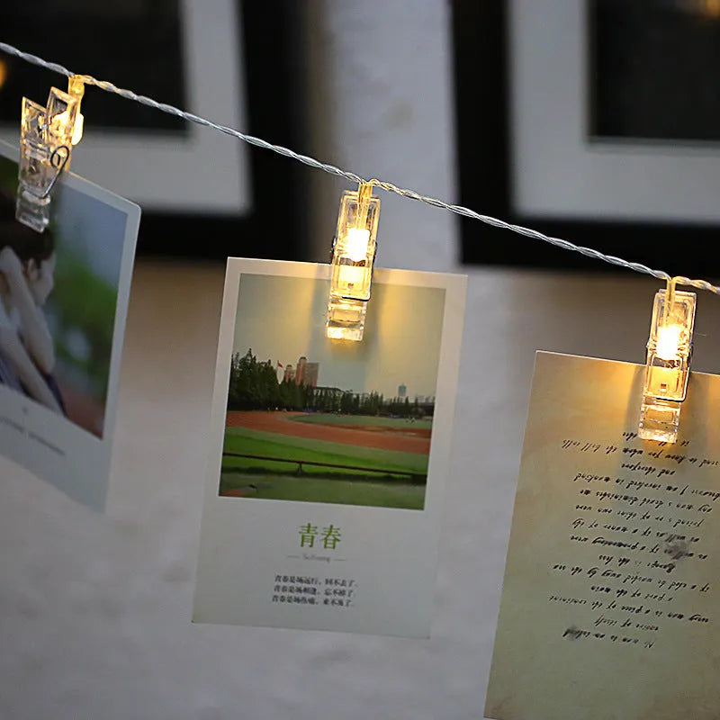 LED heart-shaped clip light string decorating a wedding cake with warm white lights.
