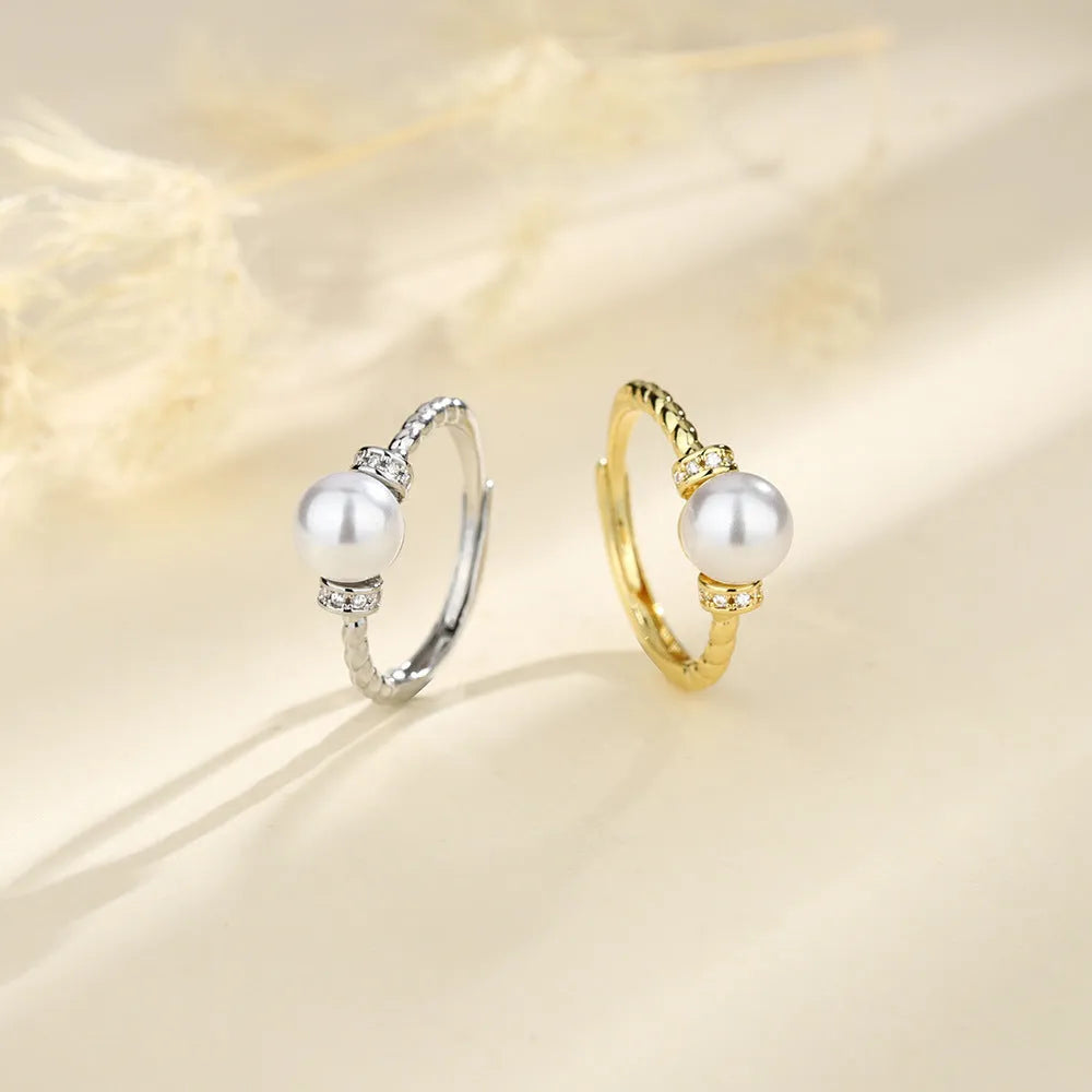 Adjustable antique twist copper ring with geometric pearl inlay in gold and silver colours.