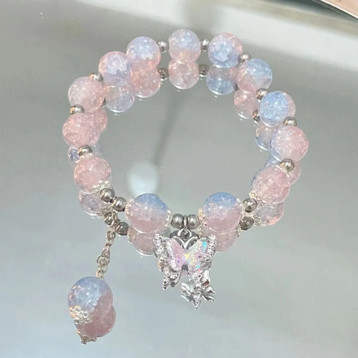 Handmade glass bead bracelet with fairy butterfly broken beads design on white background