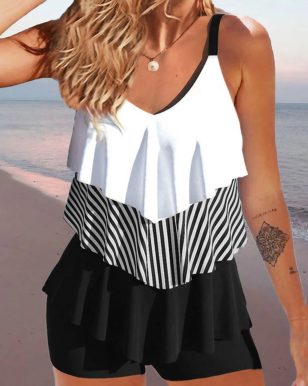 Women's sleeveless backless spaghetti-strap ruffle bikini swimsuit on a mannequin.