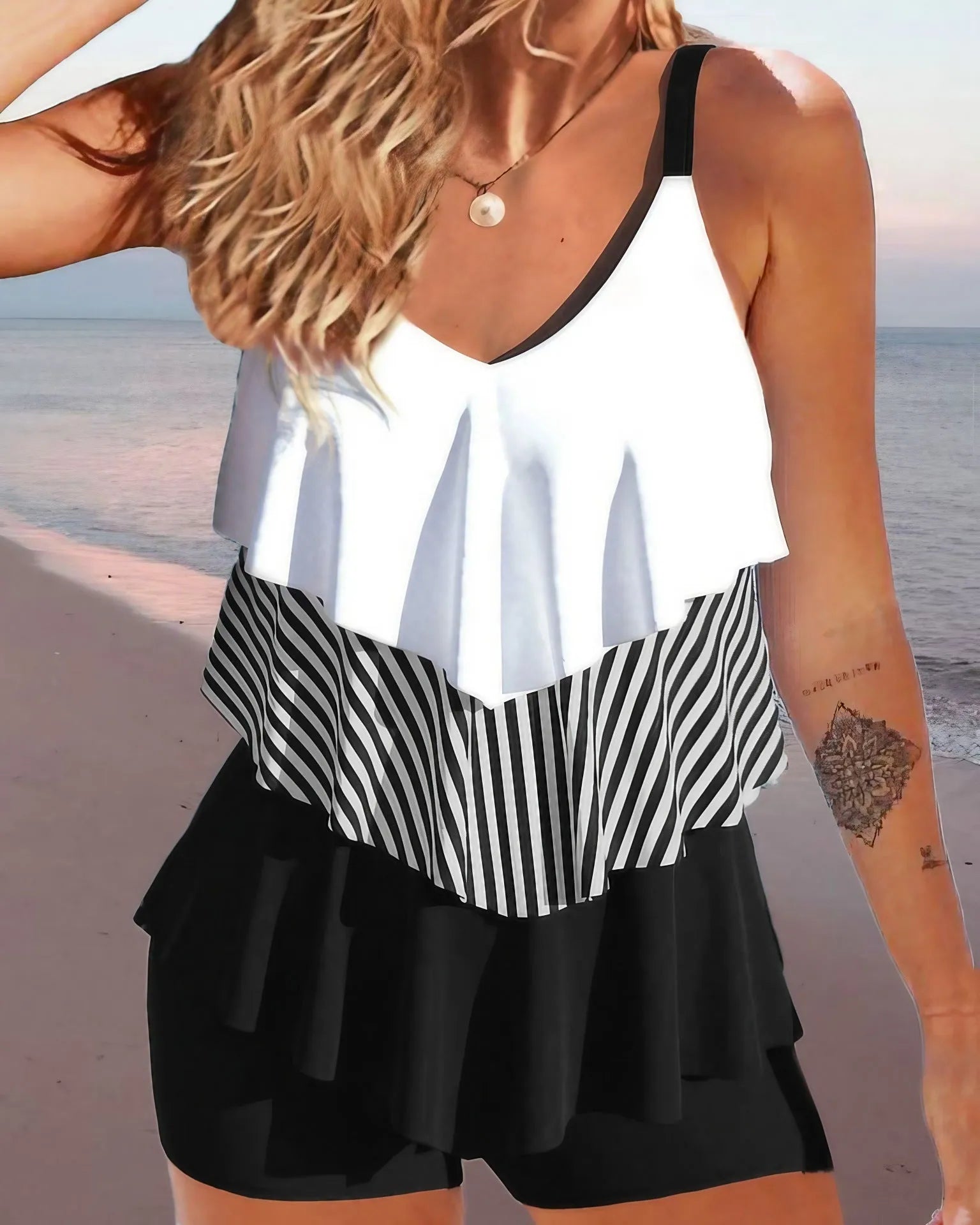 Women's sleeveless backless spaghetti-strap ruffle bikini swimsuit on a mannequin.