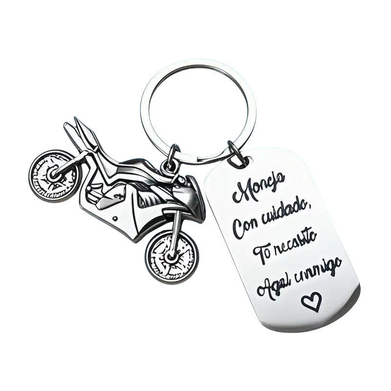 Stainless steel motorcycle-themed keychain with minimalist design, shown with its flannel storage bag.