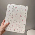 Transparent floral tri-fold protective case for Apple iPad tablet showing clear front and built-in stand