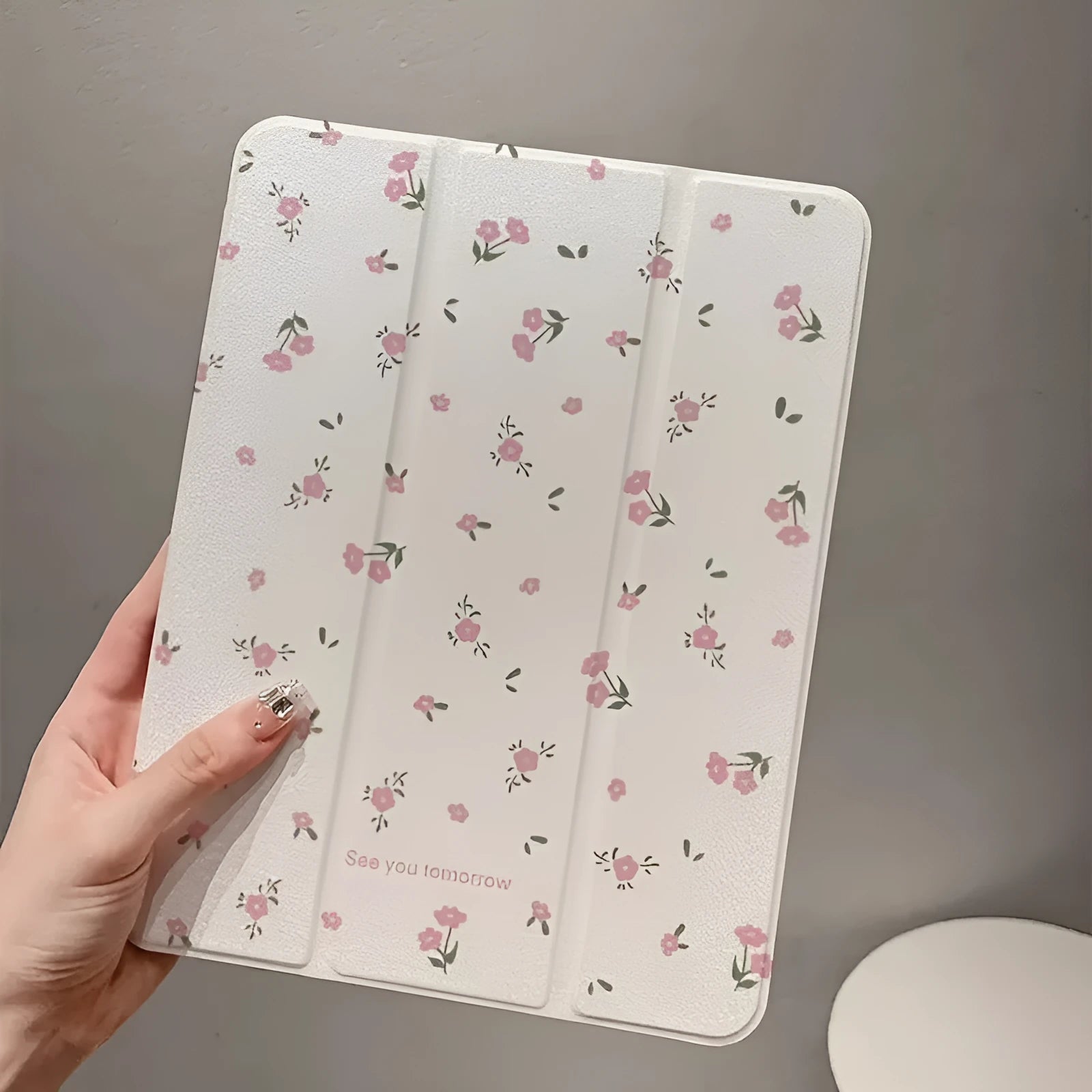 Transparent floral tri-fold protective case for Apple iPad tablet showing clear front and built-in stand