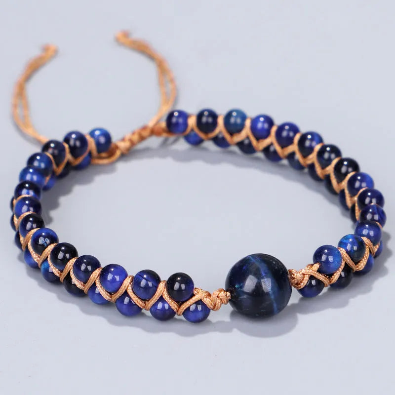Handwoven geometric bracelet made from blue Tigereye stone beads with a slip-on closure.