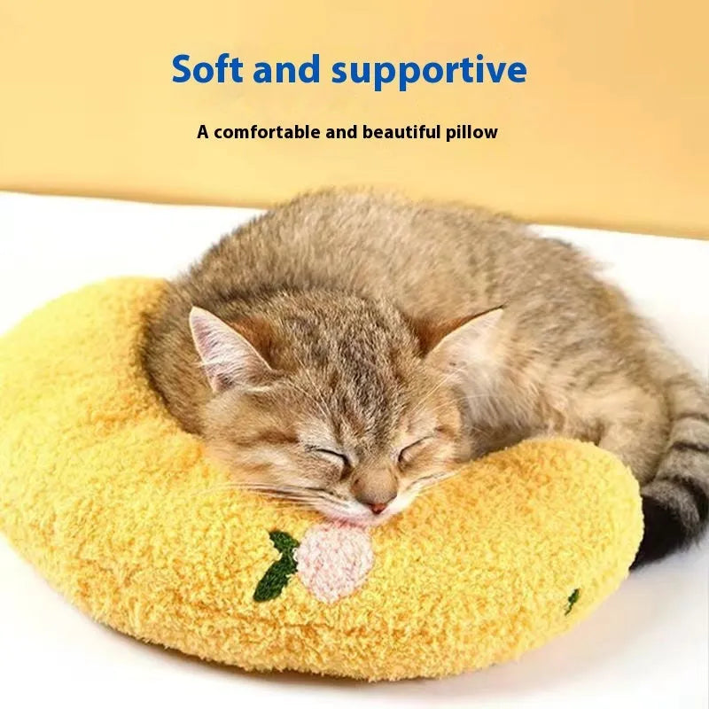 Blue cloth cat sleeping mat with a U-shaped neck pillow in a question mark style.