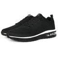 Pair of grey and black Flyknit mesh running shoes with a round toe and PU sole on a white background.