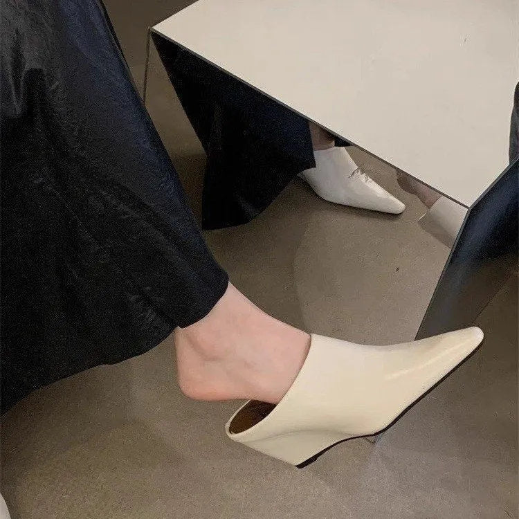 Women's black wind wedge closed toe half slippers made of PU material.