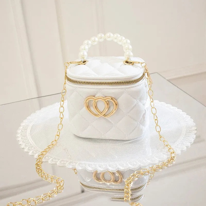 White PVC bucket bag with a red heart pattern, showing its shape and design.