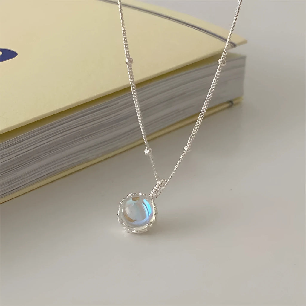 Round geometric 925 silver ornamental stone pendant on a silver curb chain necklace for women.
