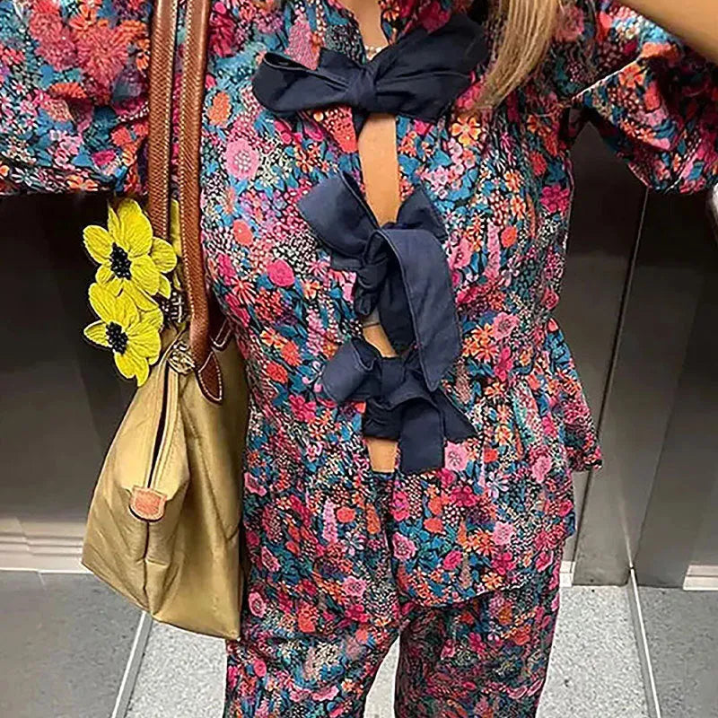 Women's floral print trouser suit set with puff sleeve blouse and matching trousers