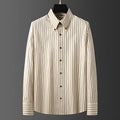 Coffee coloured striped men's long-sleeved shirt with a slim fit, shown on a hanger.