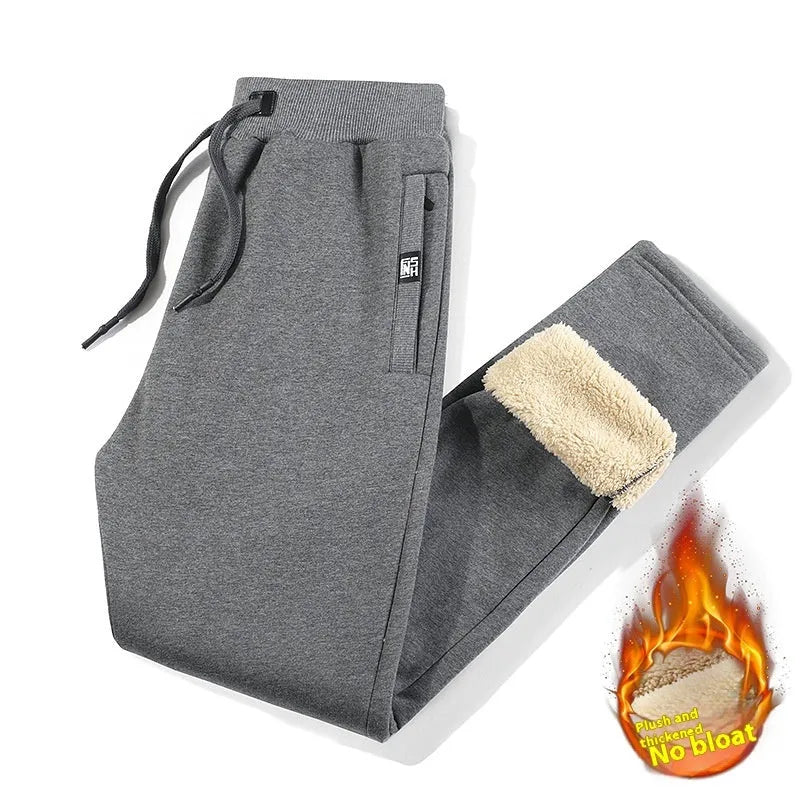 Men's grey fleece-lined oversized cotton track pants with elasticated waistband on a hanger.