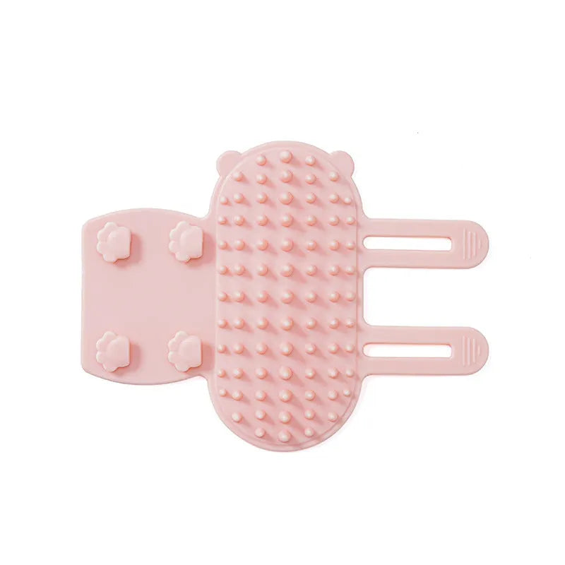 Black silicone cat grooming comb with rounded teeth and adjustable mounting strap for table legs.