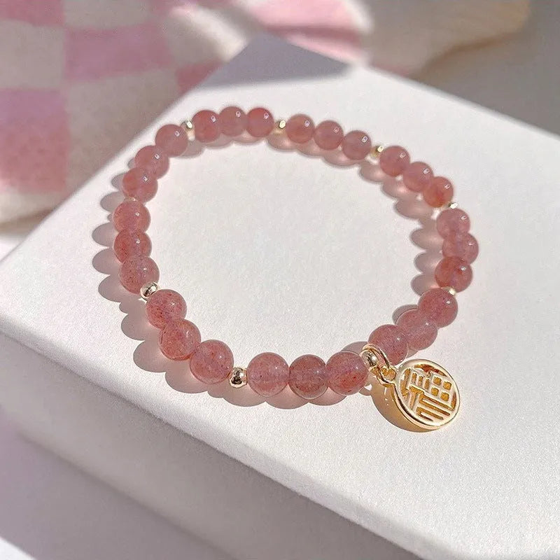 Women's strawberry quartz blessing card bracelet with glass construction and universal wrist size