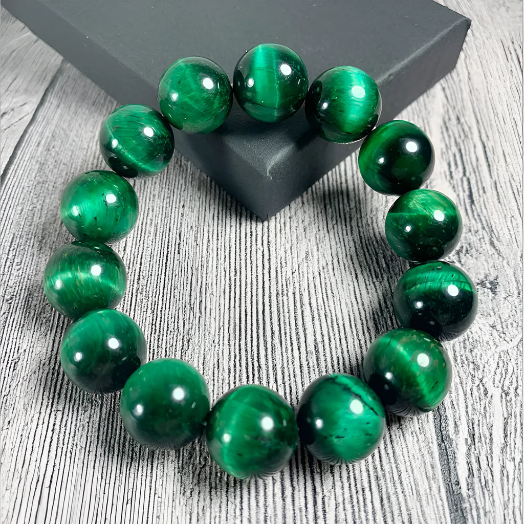 Green Tiger Eye stone beaded bracelet with polished geometric beads on a white background.