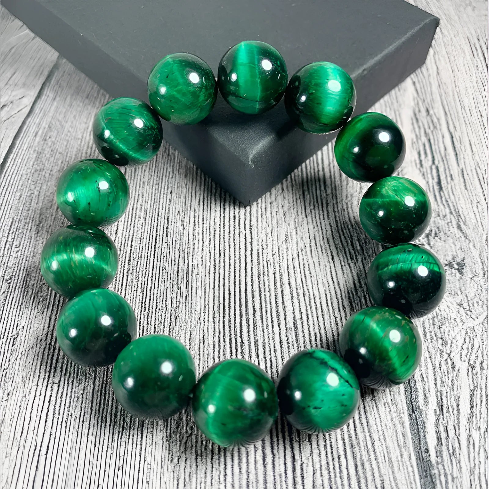 Green Tiger Eye stone beaded bracelet with polished geometric beads on a white background.