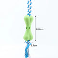 Green porous rope bone dog chew toy with knotted texture for treat stuffing and teeth relief