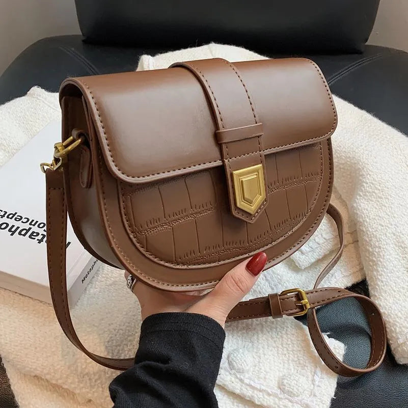 French one shoulder saddle bag for women with lock and stone pattern, available in beige