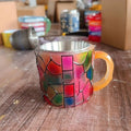 Painted synthetic resin bookmark and coffee cup decorative ornament in library or pattern style.